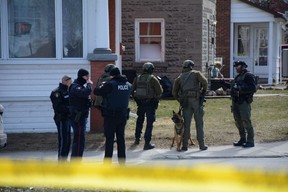 Police surround a home in Smiths Falls on Thursday, Mar. 21, 2024 while searching for a wanted man. He was later arrested in a different home across town.