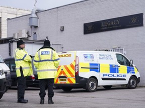 Police stand outside the Hessle Road branch of Legacy Independent Funeral Directors in Hull, England