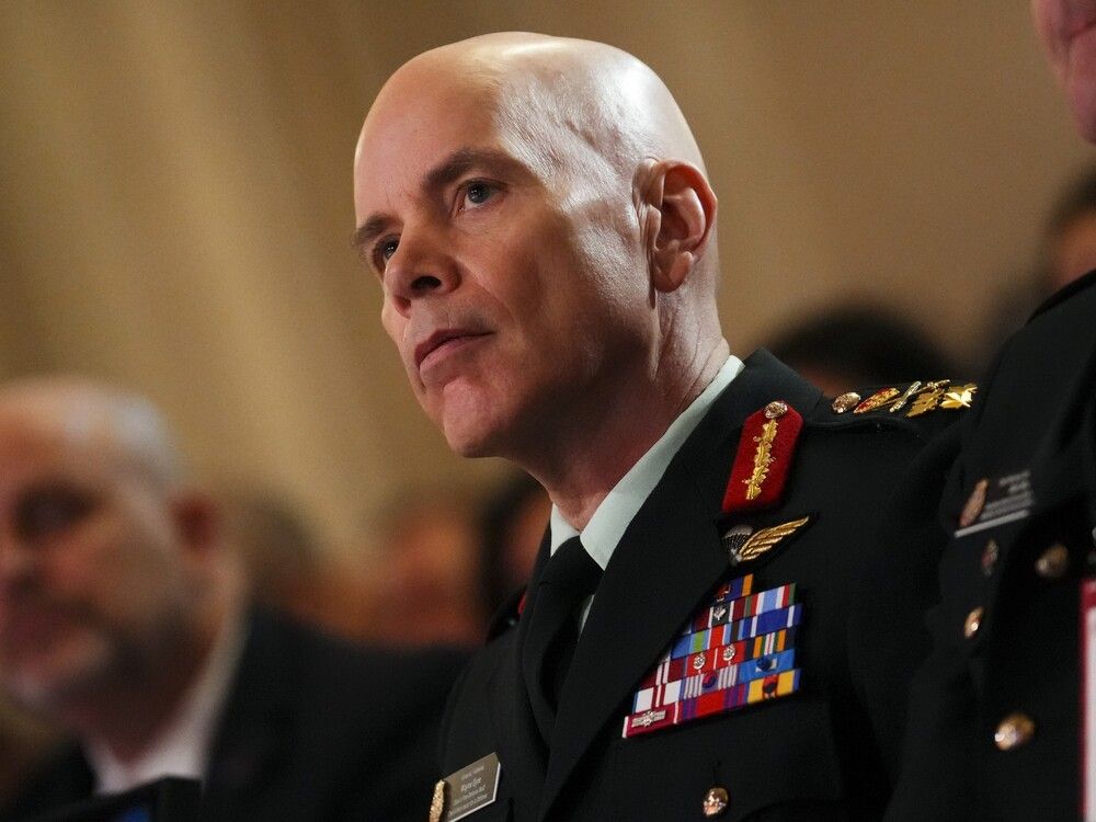 Gen. Wayne Eyre listens as Defence Minister Bill Blair speaks during the Ottawa Conference on Security and Defence on March 7. Eyre's office is refusing to release a copy of the remarks he made himself during that conference.