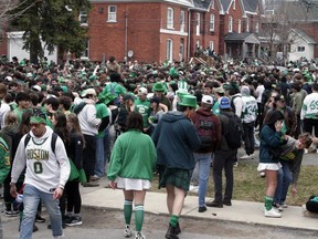 Thousands of students fill a section of Aberdeen Street in Kingston on Saturday, to mark St. Patrick's Day under the watchful eye of police officers and City of Kingston officials.