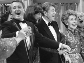 Then-Prime Minister Brian Mulroney leads the chorus in singing an Irish song on stage with his wife (Mila) and U.S. President Ronald Reagan and First Lady Nancy Reagan at the conclusion of a gala performance in Quebec City March 17, 1985. Mulroney died in Palm Beach, Fla., on Thursday, Feb. 29, 2024, at the age of 84.