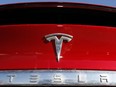 The Tesla company logo is shown in Littleton, Colo.