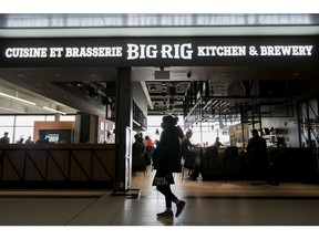 A passenger walks past a Big Rig at the Ottawa Macdonald–Cartier International Airport Canada/International gate in Ottawa, on Monday, Feb. 26, 2024.