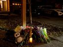 Flowers are placed Thursday outside the Barrhaven house where six people were killed and another was injured late Wednesday.