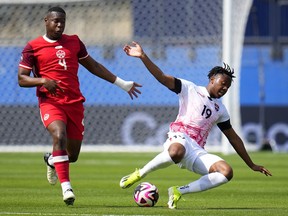 Canada defender Kamal Miller (4) works against Trinidad and Tobago midfielder Ajani Fortune (19) for control of the ball during a CONCACAF Nations League Play-In match, Saturday, March 23, 2024, in Frisco, Texas.