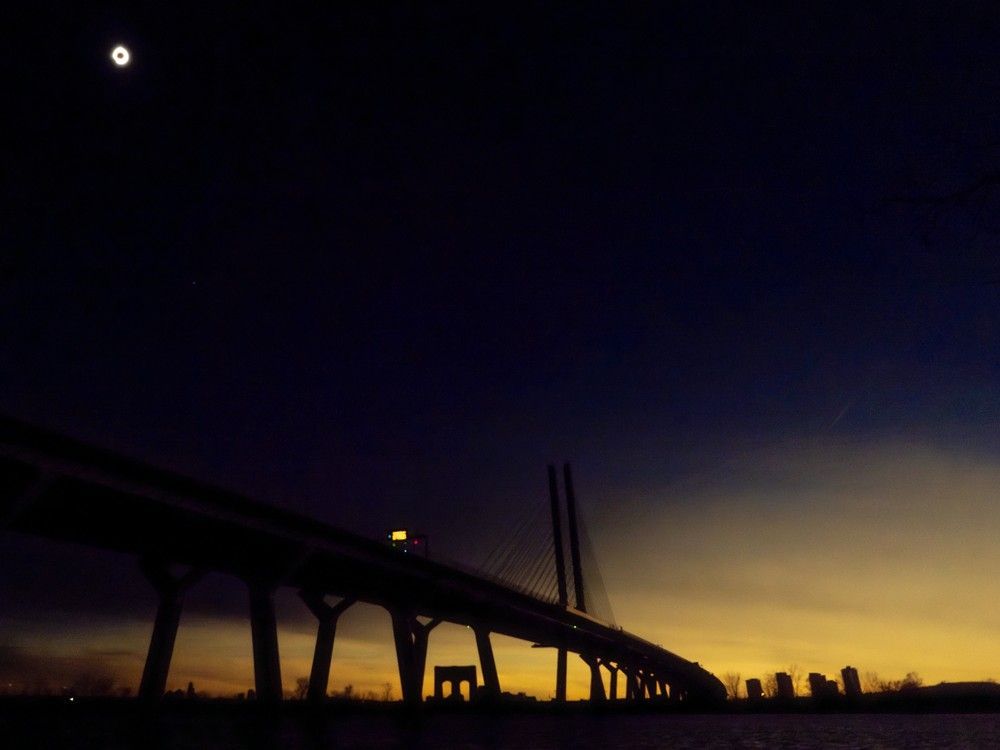  People watch the total solar eclipse at Parc Jean Drapeau, in Montreal, Monday, April 8, 2024.