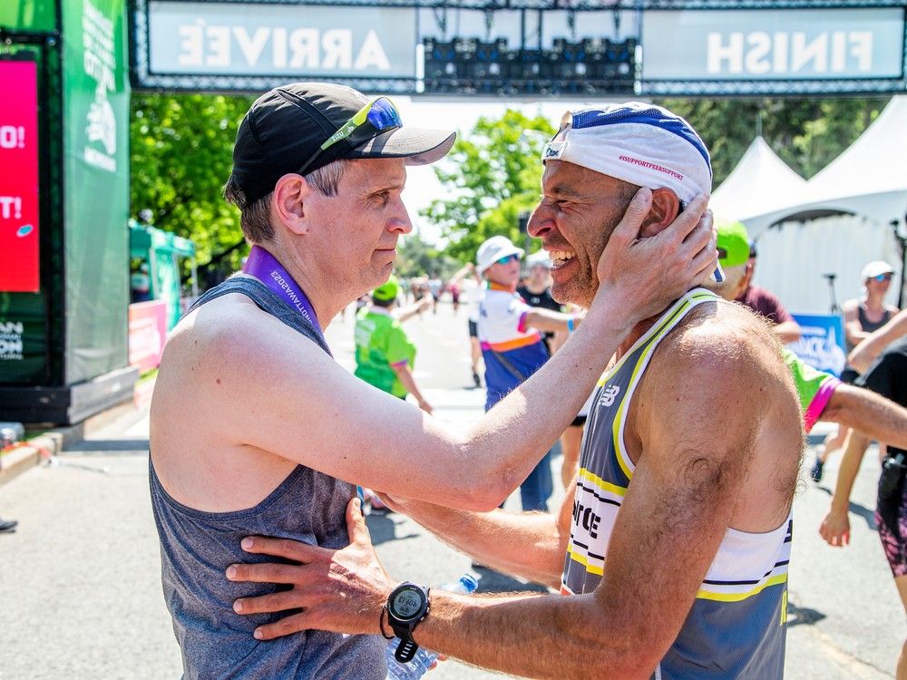 Mayor Mark Sutcliffe and Ben Kaplan share a moment after they finished the 2023 Ottawa Marathon. Kaplan ran the 42.195-kilometre course as a pace-setter for Sutcliffe.