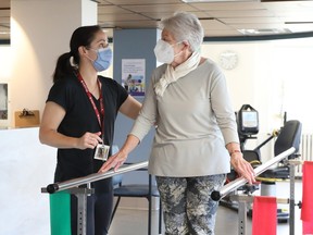 Valerie May, a physiotherapist at Bruyère Geriatric Day Hospital, helps patient Mildred Breault do her balance work.