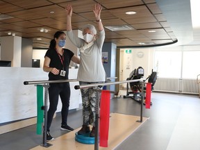 Valerie May, a physiotherapist at Bruyère Geriatric Day Hospital, helps Mildred Breault do her physiotherapy.