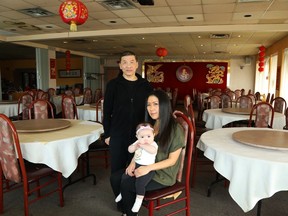 Nathalie Shienh holds her daughter, Danielle Greer, while photographed with her uncle, Johnny Shienh, in the dining room of the Mandarin Ogilvie.