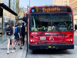 OC Transpo passengers board a bus on Rideau Street