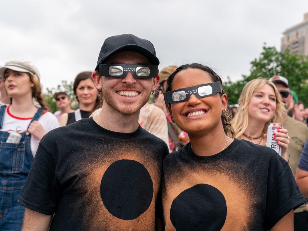  A couple wearing protective eyewear and matching eclipse t-shirts smile during a solar eclipse in Austin, Texas on April 8, 2024. This year’s path of totality is 115 miles (185 kilometres) wide and home to nearly 32 million Americans, with an additional 150 million living less than 200 miles from the strip. The next total solar eclipse that can be seen from a large part of North America won’t come around until 2044. (Photo by SUZANNE CORDEIRO / AFP)