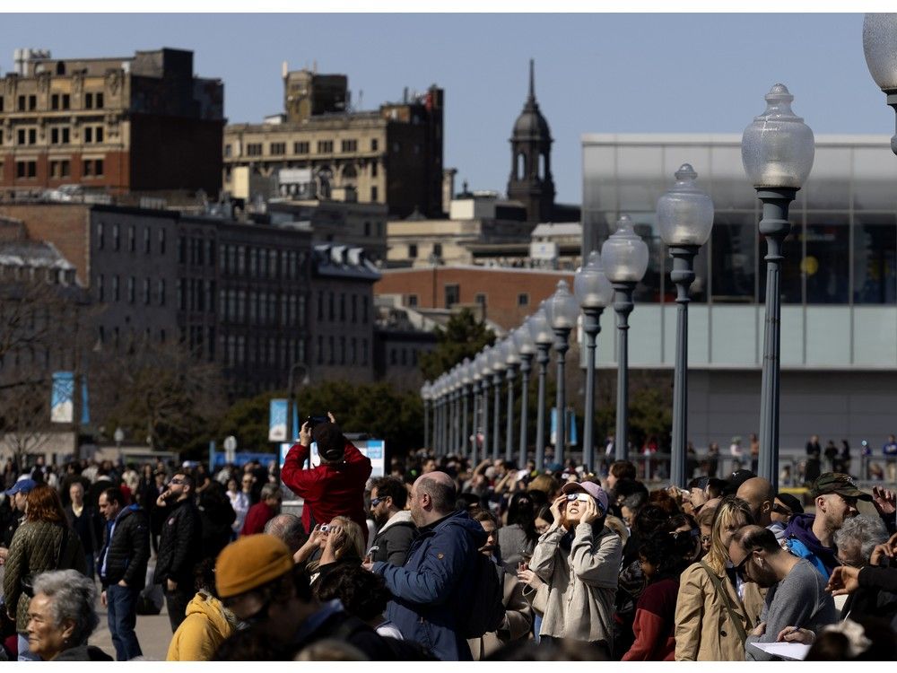  MONTREAL, QUE.: April 8, 2024 — Large crowds gather in the Old Port during the solar eclipse, in Montreal, on Monday, April 8, 2024.