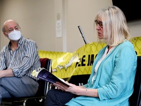 Sally Lane reads from her book, Reasonable Cause to Suspect, while Matthew Behrens, of the advocacy group Stop Canadian Involvement in Torture, listens at the Brockville Public Library on Saturday, April 13, 2024 in Brockville, Ont. (RONALD ZAJAC/The Recorder and Times)