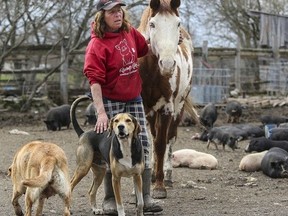 Kris Uens, who owns and operates Kamp Kiki Animal Sanctuary in Plainfield, is facing foreclosure on her 100-acre farm property, which houses approximately 200 animals. She's pictured at her home on Tuesday.