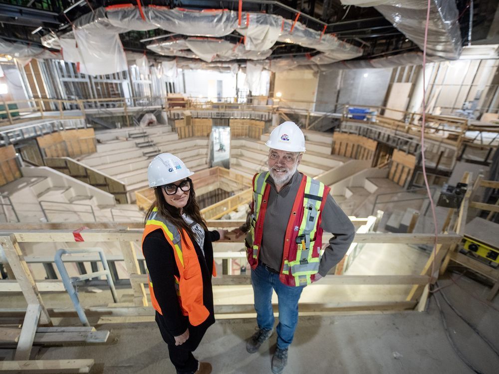 Jaime Boldt, left, executive director and principal consultant of the Globe Theatre, and Dean Tanner, project manager with Ledcor Construction, stand in the main theatre during a tour of the construction site of the renovation of the Globe Theatre in Regina, Thursday, April 4, 2024.
