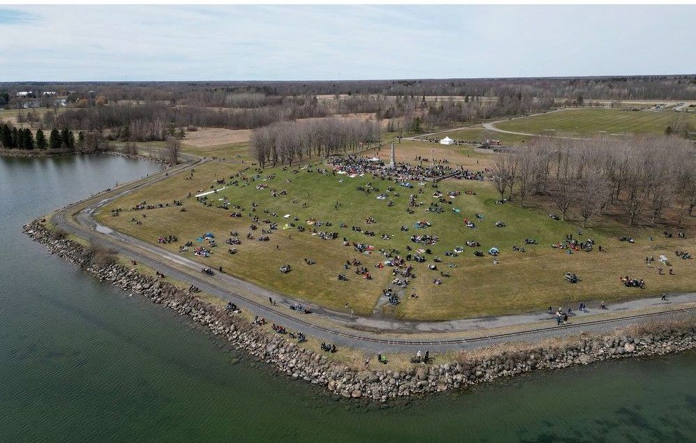 Families arrive at Crysler's Farm outside Cornwall Monday to prepare to get a look at the total eclipse.