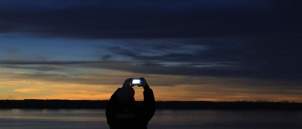  Families and friends take in the eclipse at Crysler’s Farm outside Cornwall Monday. A man takes some photos while it is dark Monday.