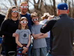 Families and friends take in the eclipse at Crysler's Farm outside Cornwall Monday.