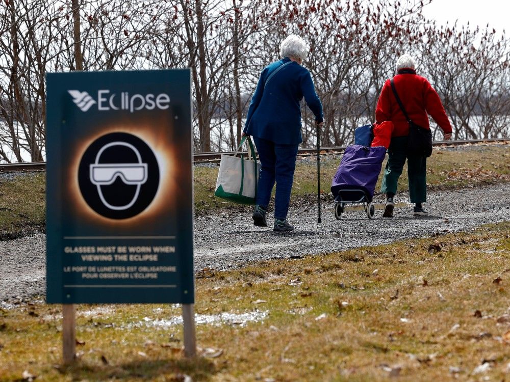Families arrive at Chrysler's Farm outside Cornwall Monday to prepare to get a look at the total eclipse.