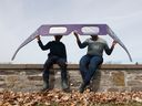 Donna Francis and her son, Jonathan, view the sun through giant eclipse glasses at Crysler's Farm Monday.