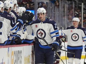 Winnipeg Jets centre Sean Monahan, front right, is congratulated after scoring in the first period of an NHL hockey game against the Colorado Avalanche, Saturday, April 13, 2024, in Denver.