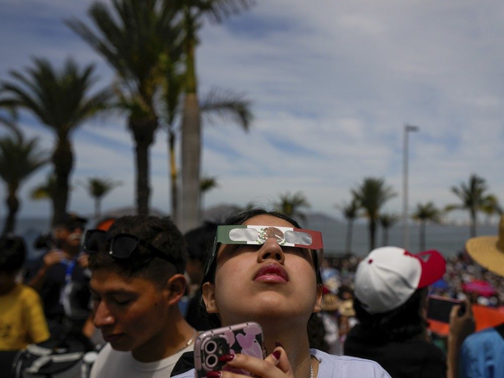  People use special glasses to watch a total solar eclipse in Mazatlan, Mexico, Monday, April 8, 2024.