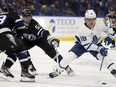 Toronto Maple Leafs right wing William Nylander (88) works around Tampa Bay Lightning left wing Austin Watson (51) and left wing Conor Sheary (73) during the first period of an NHL hockey game Wednesday, April 17, 2024, in Tampa, Fla.