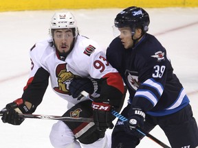Former Ottawa Senators centre Mika Zibanejad is tied up by Winnipeg Jets defenceman Toby Enstrom in 2014.