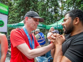 Ottawa Mayor Mark Sutcliffe was greeted at the finish line by Dhanushka Wickramasinghe, who presented him with his 50th annual Tartan Ottawa International Marathon medal at Tamarack Ottawa Race Weekend Sunday, May 26, 2024. The mayor had been raising money to support Wickramasinghe after the tragic death of his family.