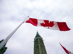 In this file photo taken on December 04, 2015 a Canadian flag flies in front of the peace tower on Parliament Hill in Ottawa, Canada.
