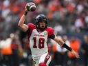 Ottawa Redblacks quarterback Dustin Crum looks for an open receiver as he runs with the ball during the first half of a CFL football game against the B.C. Lions, in Vancouver last September.