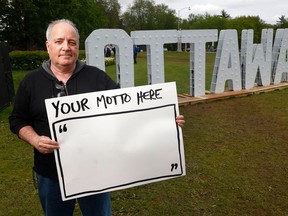 Bruce Deachman in front of Ottawa sign