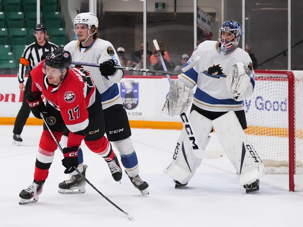 The Belleville Senators' Stephen Halliday screens Cleveland goalie Jet Greaves while drawing the attention of defenceman Stanislav Svozil during the first period at the CAA Arena in Belleville on Wednesday, May 1, 2024.