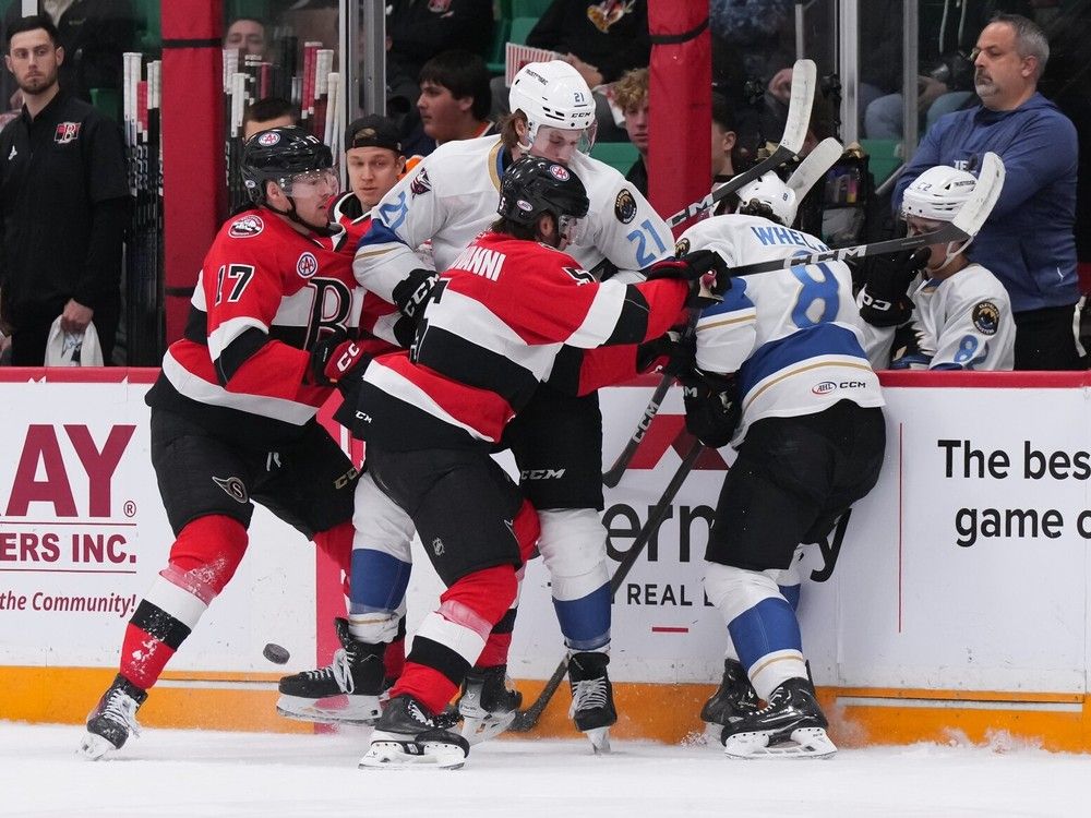 The Belleville Senators' Stephen Halliday (No. 17) and Wyatt Bongiovanni get tangled up with Cleveland's Alex Whelan (No. 8) and Josh Dunne along the boards during the first period at the CAA Arena in Belleville on Wednesday, May 1, 2024.
