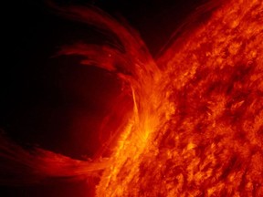 Image shows a solar flare exploding from the Sun's surface, A severe solar storm is expected this weekend.