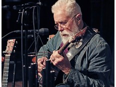 Bruce Cockburn plays guitar