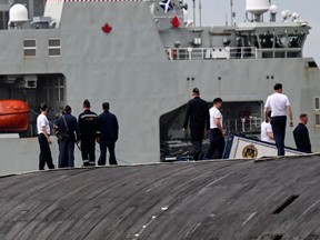 Russian Marines standing on top of the Russian nuclear-powered submarine Kazan (R), part of the Russian naval detachment visiting Cuba, watch Canada's HMCS Margaret Brooke, the second Harry DeWolf-class offshore patrol vessel for the Royal Canadian Navy (RCN), upon arrival in Havana Harbor on June 14, 2024.