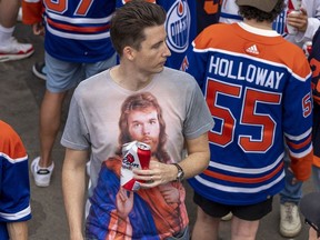 An Oilers fan wearing a Connor McDavid t-shirt is among thousands of fans waiting for Game 6 of the NHL Stanley Cup Final to begin on Friday, June 21, 2024 in Edmonton.