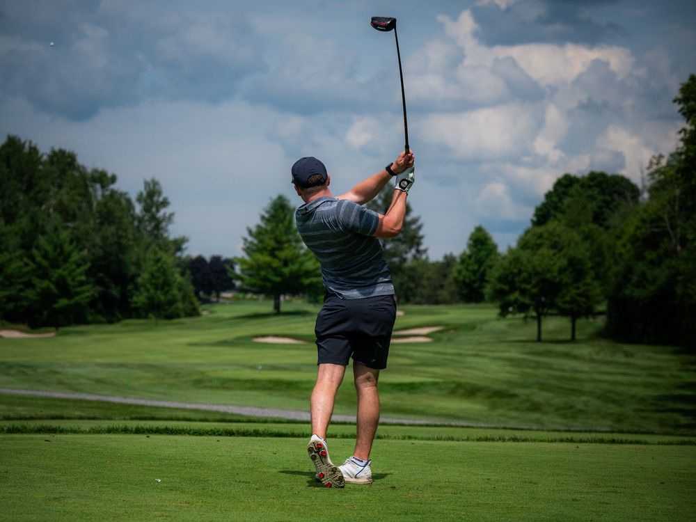 Golfer takes a swing