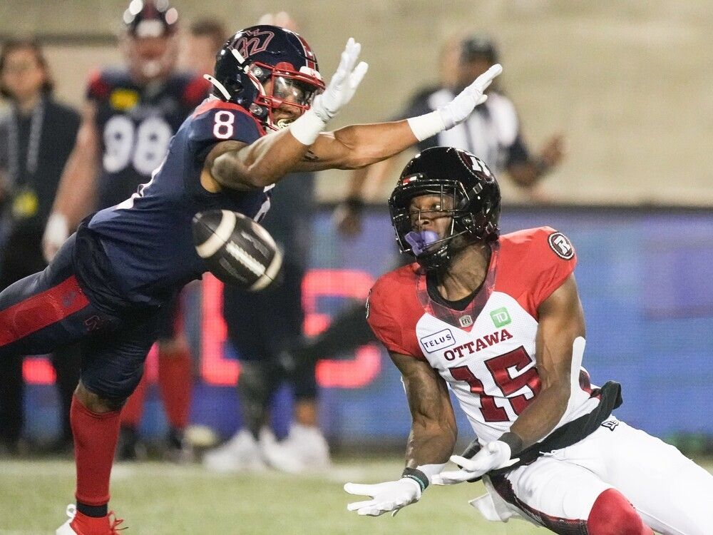 Redblacks receiver Dominique Rhymes (15) makes a catch in front of Alouettes defensive back Nafees Lyon in a game at Montreal on June 20.
