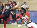 Redblacks receiver Dominique Rhymes (15) makes a catch in front of Alouettes defensive back Nafees Lyon in a game at Montreal on June 20.