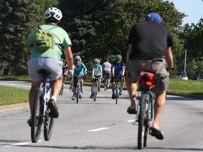 Ottawans cycling on one of the parkways in summer