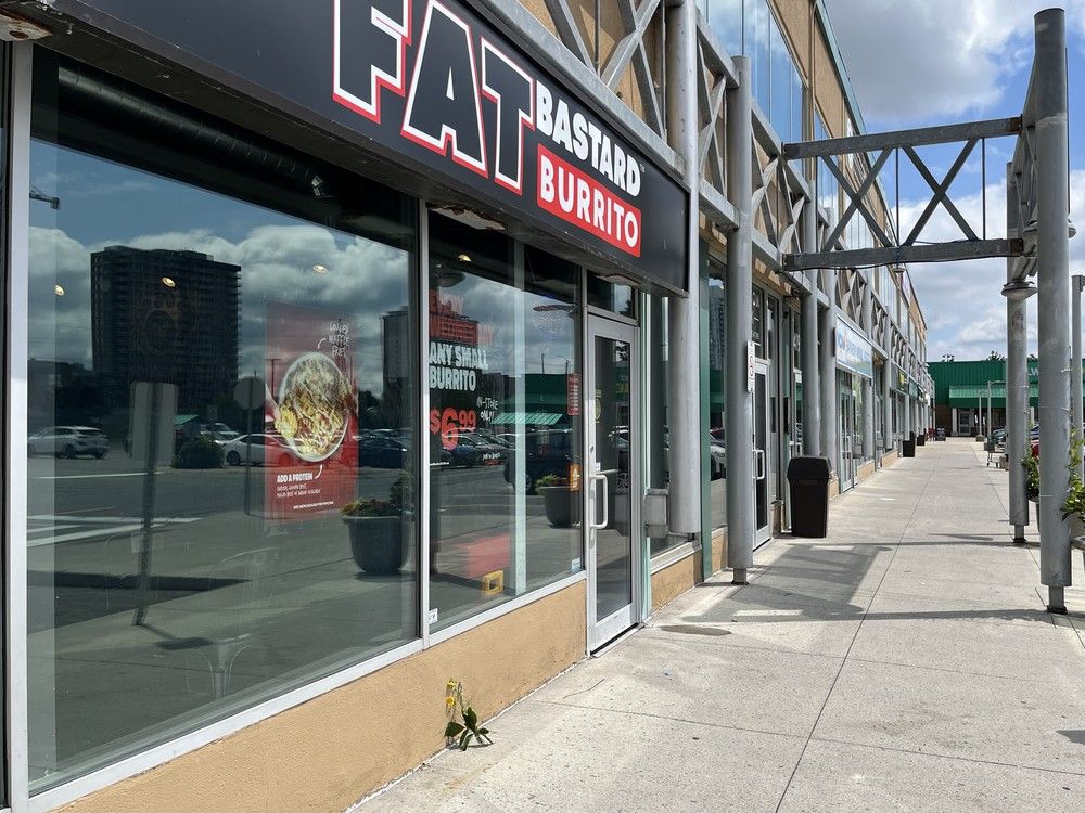 A handful of flowers outside the Fat Bastard Burrito at Hampton Park Plaza on Saturday, July 6, 2024, mark the location of a fatal shooting that happened the night before.