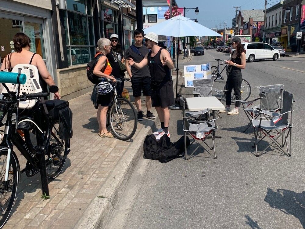 The community organization StrongTownsOttawa.ca promotes its arguments in favour of a parking ban on a busy stretch of Bank Street during an event near Second Avenue on Saturday.