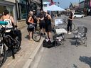 The community organization StrongTownsOttawa.ca promotes its arguments in favour of a parking ban on a busy stretch of Bank Street during an event near Second Avenue on Saturday.