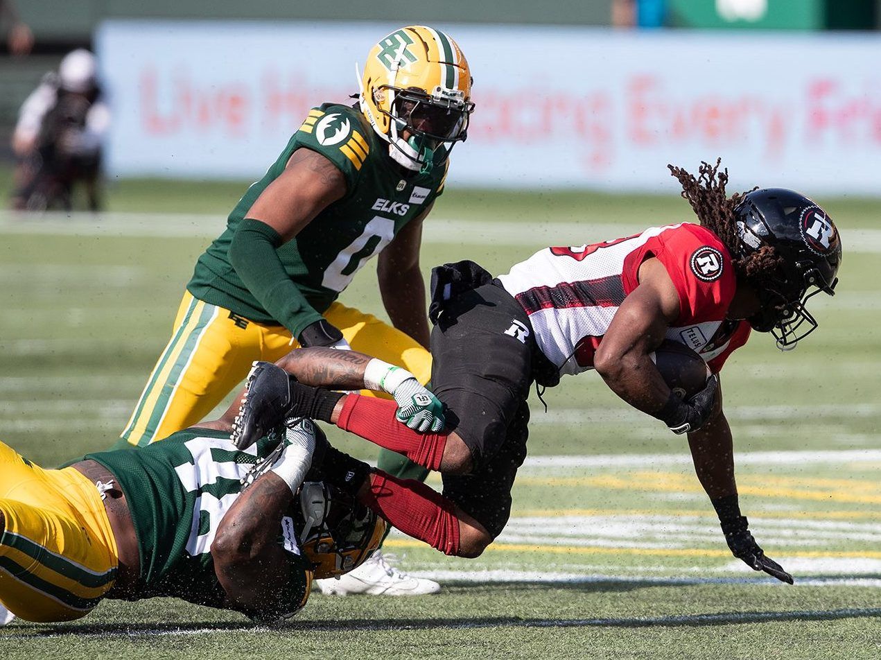 Ottawa Redblacks' Kalil Pimpleton (83) is tackled by Edmonton Elks' Nick Anderson (48) as Loucheiz Purifoy (0) chases during first half CFL action in Edmonton, Alta., on Sunday July 14, 2024. 