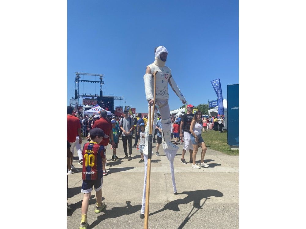 Hyppolyte Guesdon, a circus performer who does character impersonations around the world, towered over the crowd at LeBreton Flats.