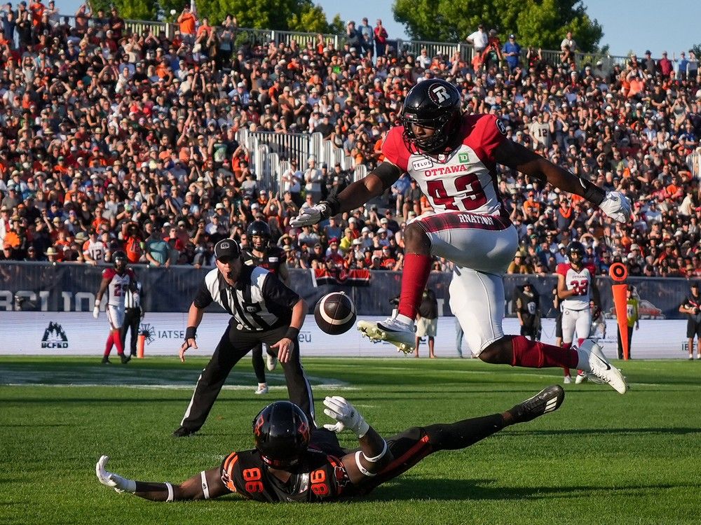 Ottawa Redblacks' Davion Taylor (43) leaps over B.C. Lions' Jevon Cottoy (86) after Cottoy failed to make the reception in the end zone during the second half of a CFL football game, in Victoria, B.C., on Saturday, August 31, 2024.