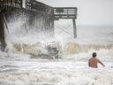 CP-Web. A surfer takes advantage of the large surf as Tropical Storm Debby approaches, Wednesday, Aug. 7, 2024, in Isle of Palms, S.C.